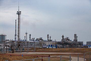 Oil refinery and gas processing plant  panorama view. Gas torch and refinery columns and lightning...
