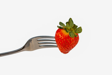 Strawberries on a fork cut out on a white background