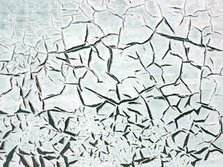 Texture of a painted wall with peeling turquoise paint that has cracked. Concept background, texture.
