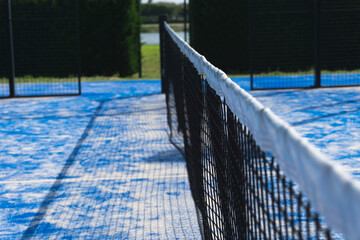 Paddle tennis outdoor court and net. Selective focus.