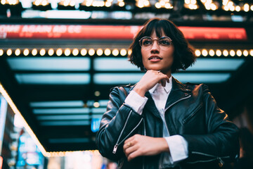 Below view of thoughtful hipster model 20 years old in stylish apparel feeling pondering at...