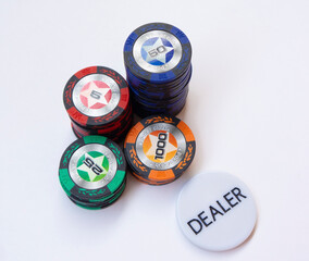 Pskov, Russia - 10.01.2020. A stack of poker chips and white dealer badge