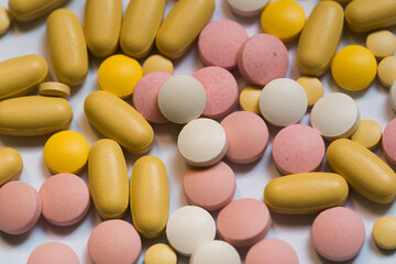 Different pills on color background, flat lay. COVID-19 (coronavirus) drugs