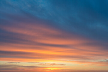 Fototapeta na wymiar Orange and blue clouds at sunrise