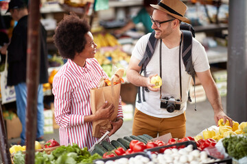 Sales of fresh and organic vegetables and  fruits at the green market or farmers market.  Buyers choose and buy products for healthy food in grocery. All for diet healthy eating, lifestyle.