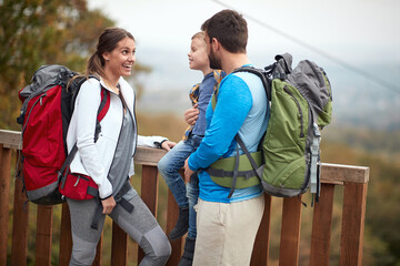 Obraz premium Happy couple with a son on a hiking; Active lifestyle concept