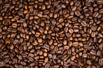 Naklejka premium Top view of brown roasted coffee beans, can be use as background, copy space for text.