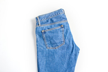 folded dark blue jeans on a white background. modern casual clothing. flat lay, top view