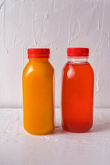 The healthy fruit drink in Eco bottles on white wooden background. Minimal style. Zero waste.