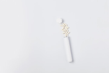 composition of an open container with pills on a white background. mockup medicine. top view, copy space