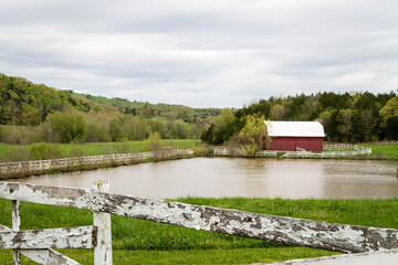 red barn white fence pond