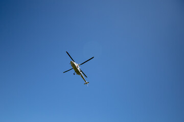 Helicopter flying in the blue sky. Themes rescue, help and hope.