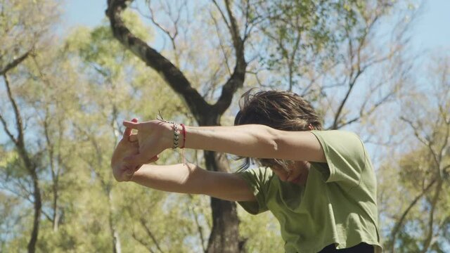 Medium shot of a pretty woman doing yoga stretching exercices at park. High quality 4k footage with copy space