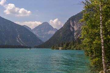 Naklejka na ściany i meble sunny day on the turquoise Lake Plansee in the Austrian Alps