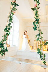 Fototapeta premium Wedding day and beautiful bride in studio. Beautiful young bride with wedding makeup and hairstyle. Portrait of young gorgeous bride. Wedding.