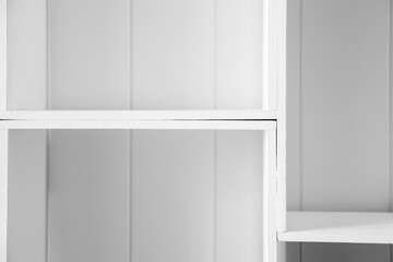 Empty white wooden shelves, modern interior