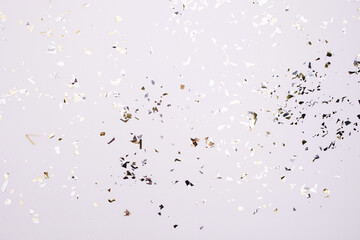 Gold and silver sparkles and glitter on off white trendy background. Festive backdrop for your projects.