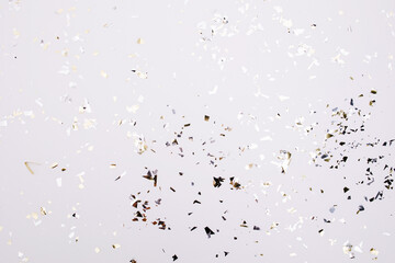 Gold and silver sparkles and glitter on off white trendy background. Festive backdrop for your projects.