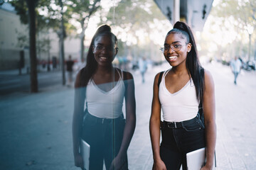 Happy African American female standing on street