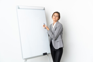 Young Ireland woman isolated on white background giving a presentation on white board
