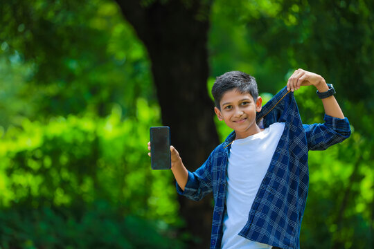 Cute Indian Schoolboy Studying Online On Tablet At Home