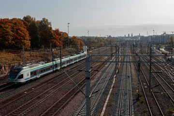 Helsinki, Uusimaa, Finland 2020 October 2, 2020 Railway tracks and a running train. Sunny, autumn...