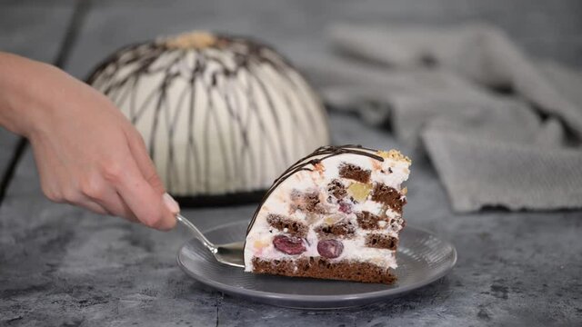 Piece of Pancho cake with pineapple and sour cream topped with chocolate and nuts.