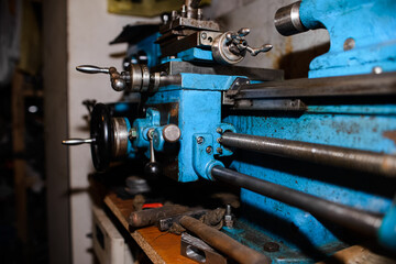 An old lathe in the garage under repair. Industrial equipment for factories. close-up
