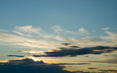 Naklejka na ściany i meble Sunset in the blue sky with white clouds