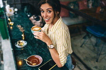 Cheerful lady having hot coffee