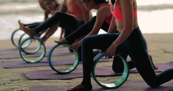 Professional group females yoga practice in class on mat stretching