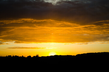 sunset over field with orange sky