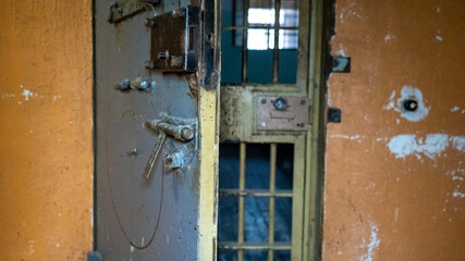 Prison's windows of metal door protect prisoner from inside to escape. Food channel through prison cell's bars. jail, detail of confinement and crime, justice. Prison interior. Limiting freedom.