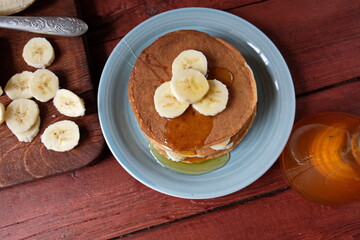 Breakfast oatmeal pancakes with banana, walnuts and honey. Traditional American Breakfast. The concept of home made healthy food.