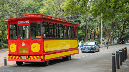 Naklejka na ściany i meble Red and Yellow Trolley Car on the Streets of Coyoacan
