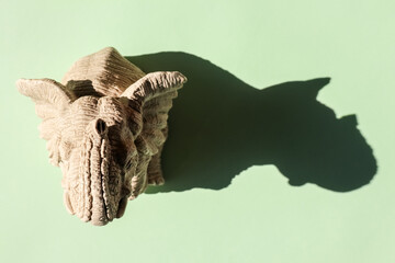 elephant statuette with a hard shadow on a plain background. the view from the top. blank for the pattern