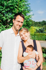 Fototapeta premium Happy parents with newborn baby outdoors