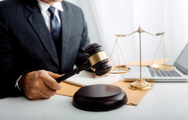 justice and law concept.Male judge in a courtroom on wooden table and Counselor or Male lawyer working in office. Legal law, advice and justice concept.
