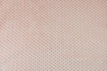 Fluffy soft baby fabric in light pink color. Soft pastel textile texture. Terry towel. Pink fabric.