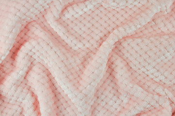 Fluffy soft baby fabric in light pink color. Soft pastel textile texture. Terry towel. Pink fabric.