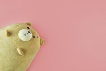Brown Teddy bear on pink background. Soft toy. Children's pink background. Valentine's day.
