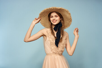 Girl in a pink dress on a blue background gestures with her hands romance model fun emotions cropped view