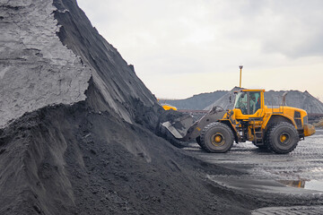 Wheel loader under operation at iron ore concentrate stockpile