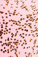 Golden sparkles on pink pastel background. Festive backdrop for your projects