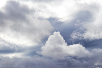 White curly cloud on a gray rainy sky
