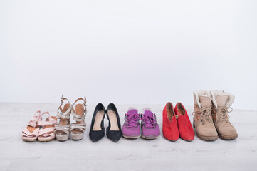 Women's choice of footwear for all seasons. Women's shoes in a row on a white background