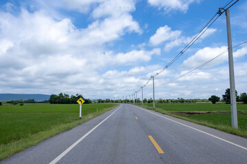 Fototapeta na wymiar Country road and blue sky