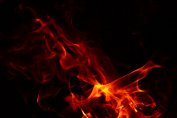 Fototapeta na wymiar Abstract glowing background. Flames on a dark background with sparks and smoke.
