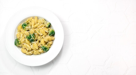 pasta with broccoli in creamy sauce in white plate