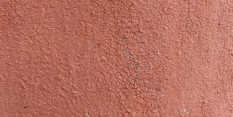Red crack wall texture. Old paint surface